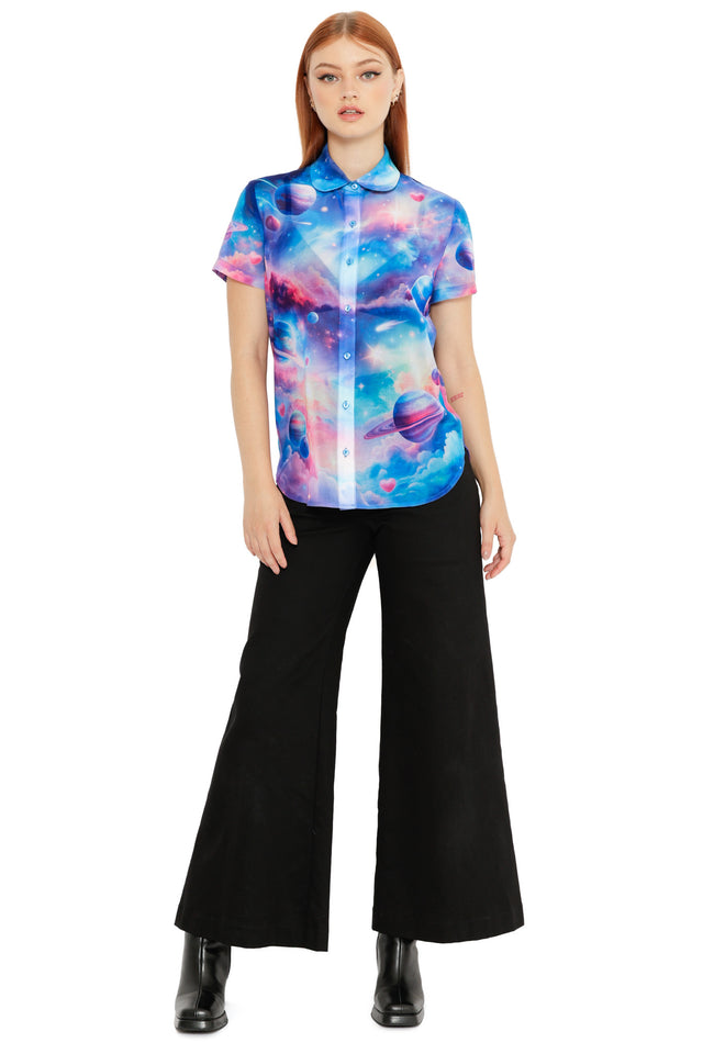 Short-sleeve button-through shirt featuring a dreamy pastel space print with planets, stars and soft cloud tones.
