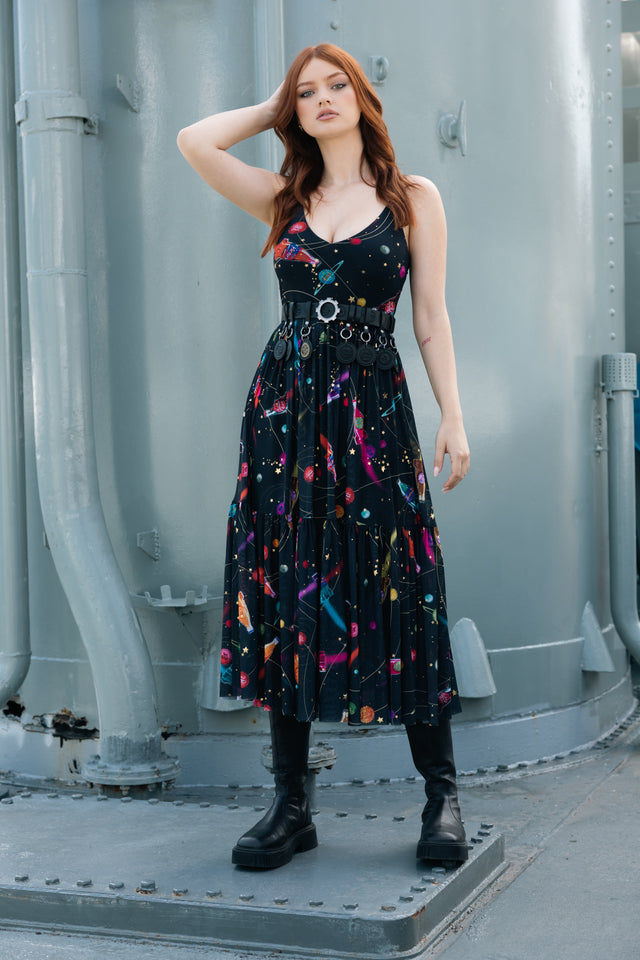 Model wearing Fallout x BlackMilk Nuka-Space Sheer Midaxi Dress featuring retro rocket ships and planets on a black background.